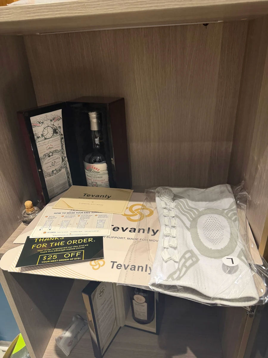 White TEVANLY Precision Compression Dial Knee Brace displayed with its packaging on a shelf.