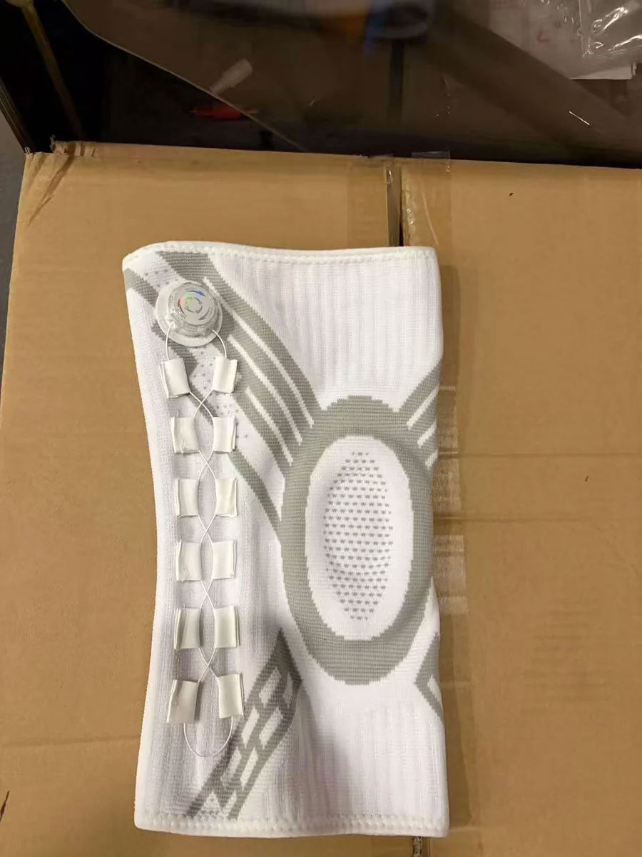 White TEVANLY Precision Compression Dial Knee Brace displayed flat on a cardboard box.